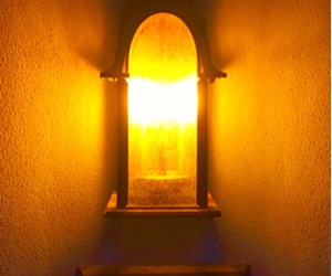 A Sweetwater Vistas porch light glowing warm amber at night
